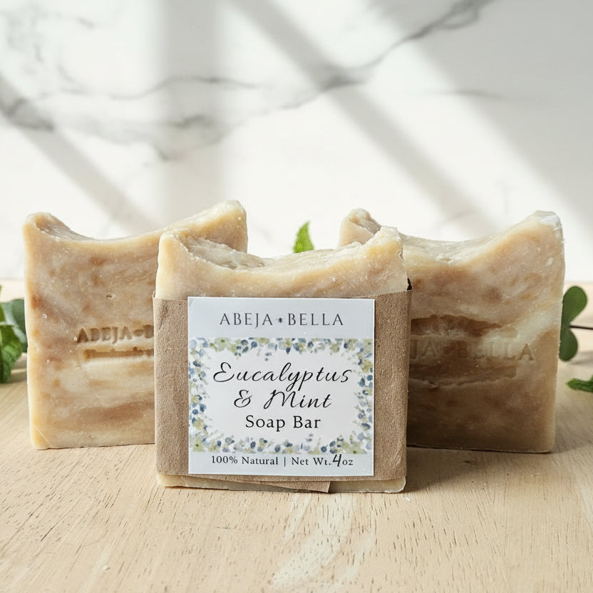 Bar of soap on a wooden soap dish with a label on a light wooden surface
