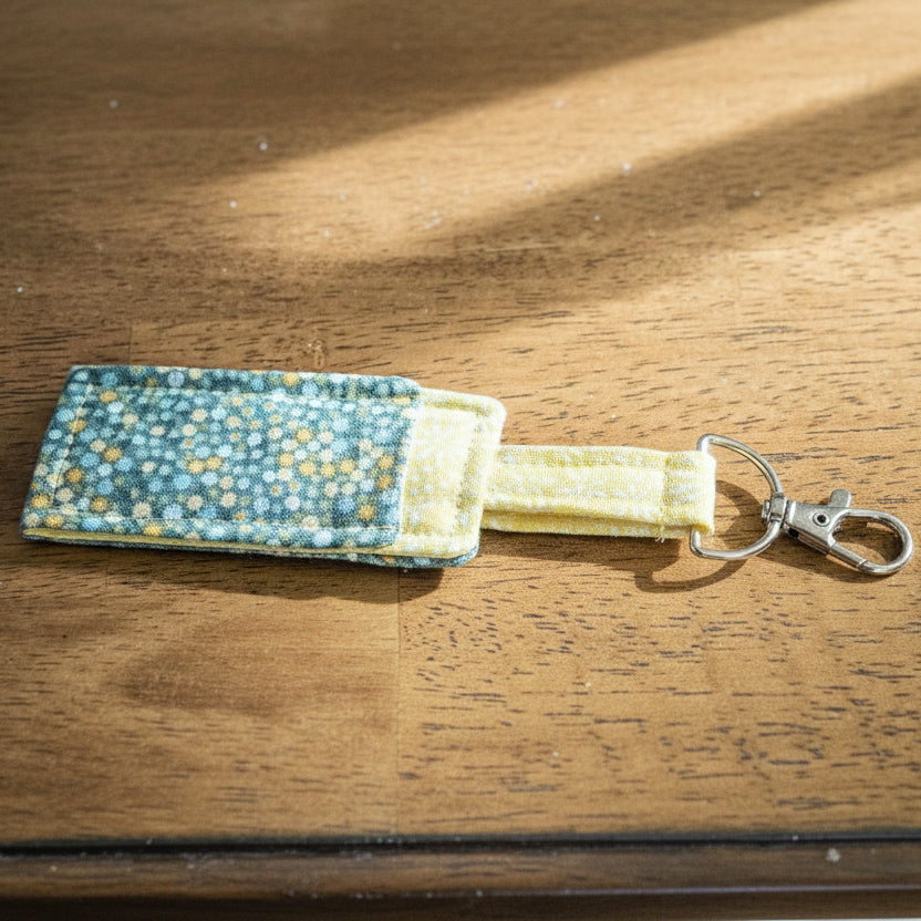 Fabric keychain with floral pattern on a wooden surface