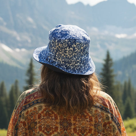 A person standing outdoors with a blue patterned bucket hat, viewed from behind.