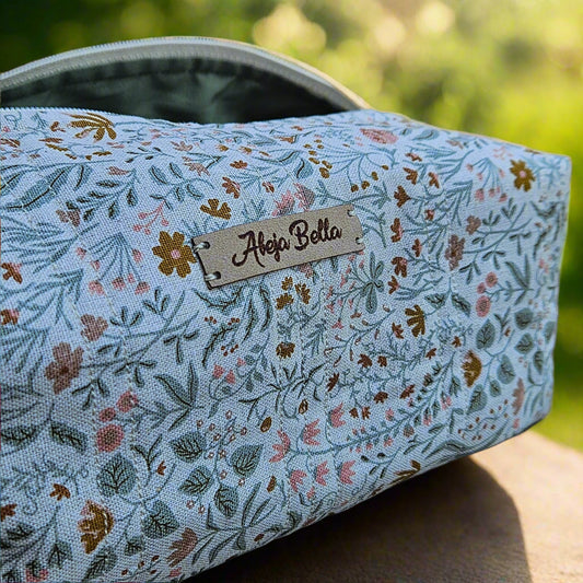 Floral-patterned product with a brand label on a wooden surface and blurred natural background