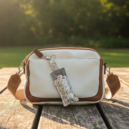 White bag with clip-on lip balm holder keychain