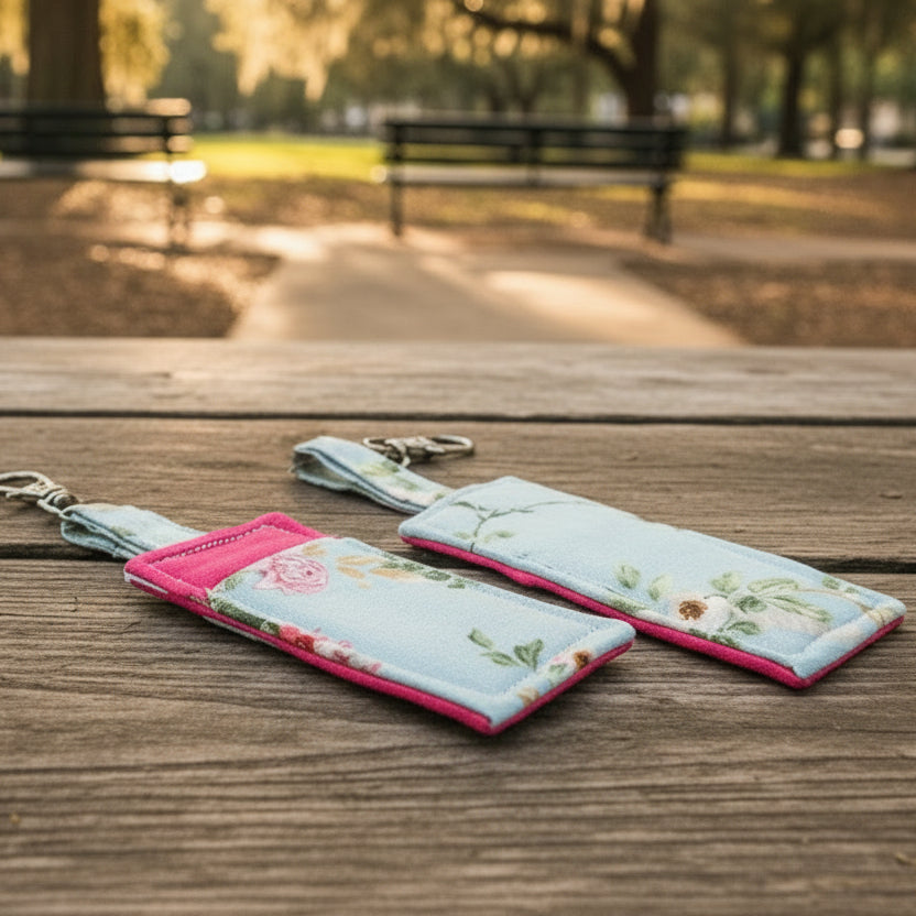 Two floral keychains on a wooden surface