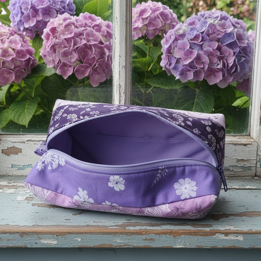 Purple floral-patterned cosmetic bag on a wooden surface