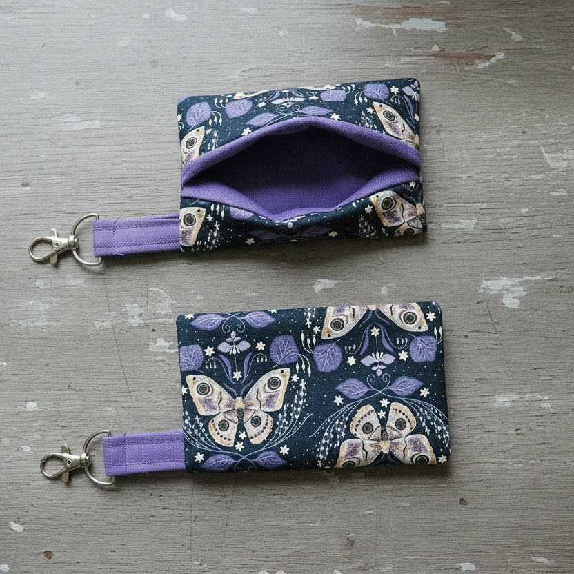 Two butterfly tissue holders on wooden surface